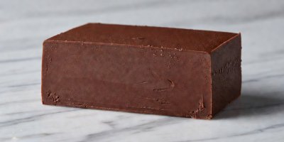Dense chilled chocolate ganache slice revealing smooth matte interior texture
